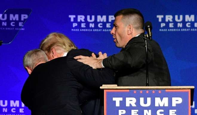 US Republican presidential nominee Donald Trump is hustled off the stage by security agents. Photo: Reuters