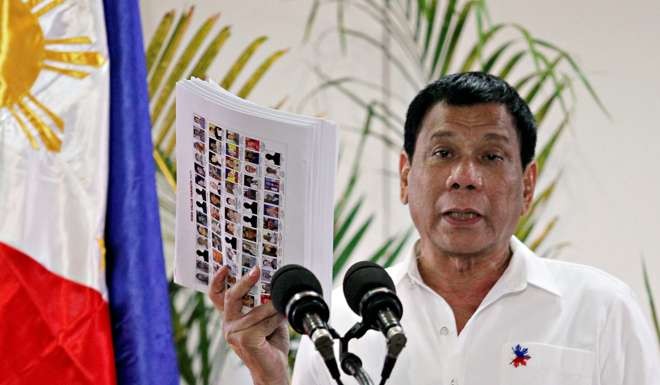Philippine President Rodrigo Duterte shows a list of government, military and police officials involved in illegal drug trade. File photo: Reuters
