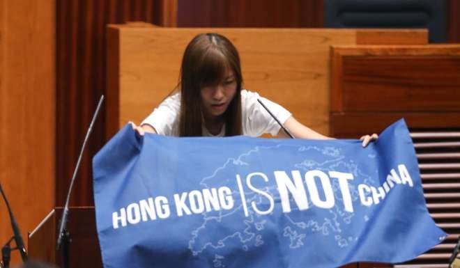 Lawmaker-elect Yau Wai-ching displaying a banner reading during her initial oath taking last month. Photo: Sam Tsang