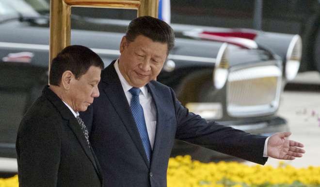 President Xi Jinping shows the way to visiting Philippine President Rodrigo Duterte during a welcome ceremony outside the Great Hall of the People in Beijing on October 20. Duterte’s pivot to China in effect capsizes Manila’s post-war security relationship with Washington. Photo: AP