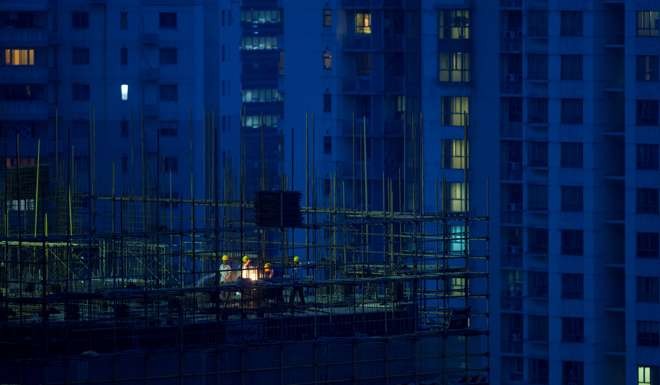 Labourers work atop scaffolding at a residential construction site in Shanghai. Following the recent price rally, China’s tier-one cities have become increasingly unaffordable. Photo: Reuters