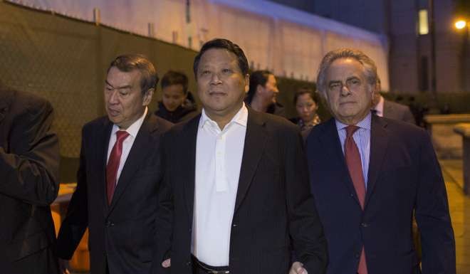 Ng Lap Seng exits the Manhattan US District Courthouse with his attorney Benjamin Brafman in New York. Photo: Reuters