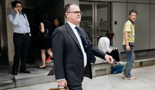 Tim Owen, lawyer of Rurik Jutting, a former Bank of America Corp. employee, leaves the High Court in Hong Kong. Jutting pleaded not guilty to murder, nearly two years after police found two women dead in his Hong Kong apartment. Photo: Bloomberg