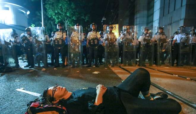 A protester obstructing police during the early Monday confrontation. Photo: Edward Wong