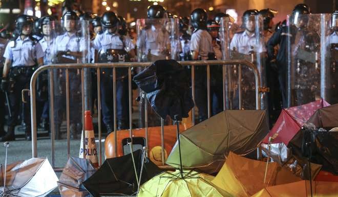 Upturned umbrellas at the barricades manned by police early Monday. Photo: K. Y. Cheng