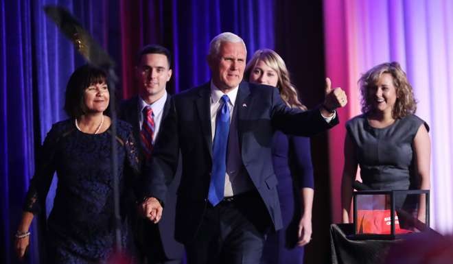 Vice-president-elect Mike Pence walks on stage along with members of his family. Photo: AP