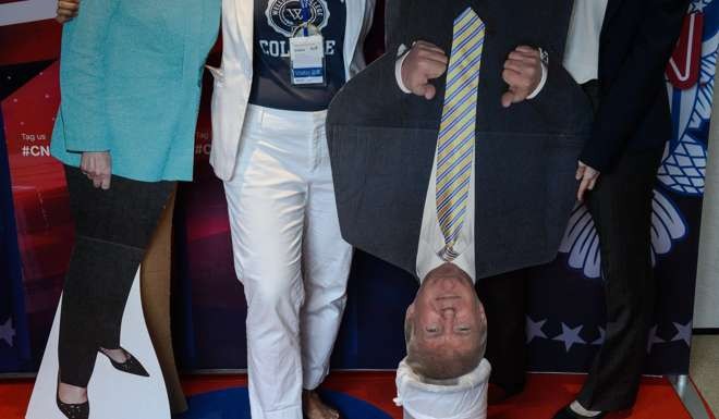 A cardboard cutout of Donald Trump is placed in a bin as people attend a live coverage of the US elections event organised by the American Chamber of Commerce in Hong Kong. Photo: AFP