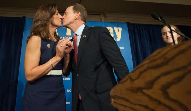 US Senator Pat Toomey of Pennsylvania kisses his wife Kris as he prepares to speak to supporters following his election victory in a highly contested senatorial race that helped the Republicans maintain control of the Senate. Photo: AFP