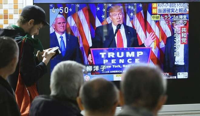 A street TV in downtown Tokyo reports that Republican Donald Trump has won the US presidential election. Photo: Kyodo
