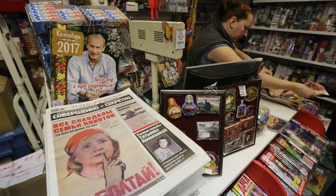 A photo illustration of Hillary Clinton on the cover of “Top Secret” newspaper beside a magazine cover showing Russian President Vladimir Putin at a news-stand at the Kursk railway station in Moscow on November 9. Photo: Bloomberg