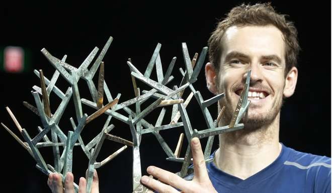 Britain's Andy Murray holds the trophy after winning the final of the Paris Masters tennis tournament against John Isner of the United States in three sets 6-3, 6-7, 6-4 at the Bercy Arena in Paris, Sunday, Nov. 6, 2016. (AP Photo/Michel Euler)