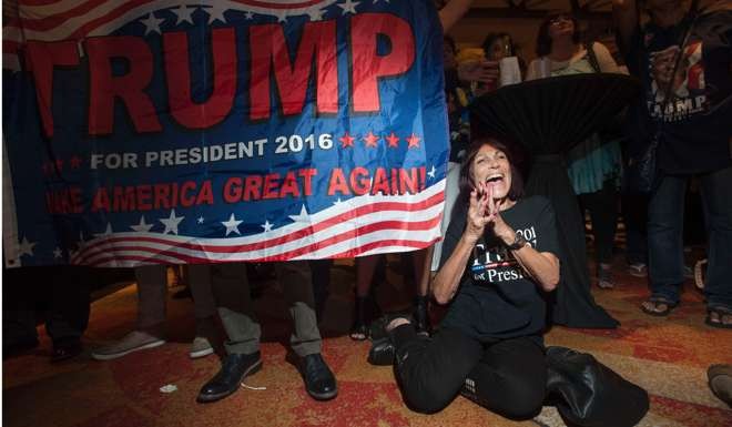 A supporter of Donald Trump cheers as election results come in during a viewing party at a hotel in downtown Phoenix, Arizona. Photo: AFP
