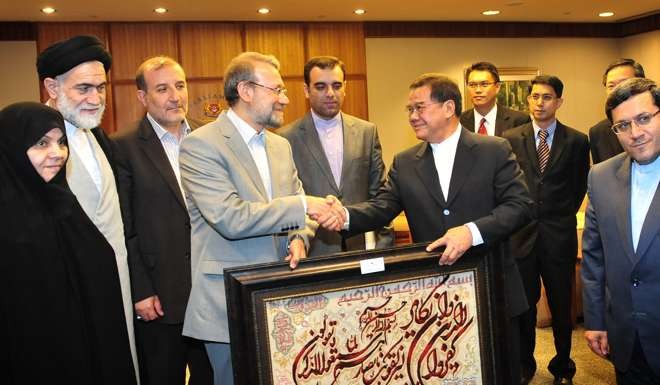 Abdullah Tarmugi receives a gift from Iranian speaker Ali Larijani, fourth from left, during a visit by senior Iranian officials to Singapore. Tarmugi is also in the running for Singapore’s presidency. Photo: AFP