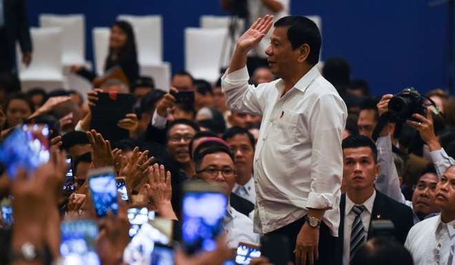 Philippine's President Rodrigo Duterte waves after meeting with Philippine nationals living in Malaysia during an official visit in Kuala Lumpur. Photo: AFP