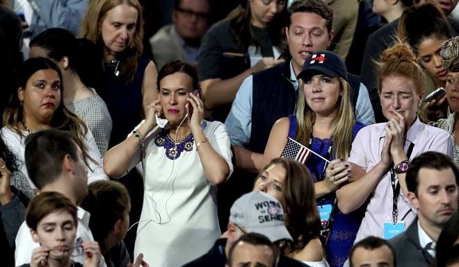 People react to the voting results at Democratic presidential nominee former Secretary of State Hillary Clinton's election night event at the Jacob K. Javits Convention Centre in New York City. Photo: AFP