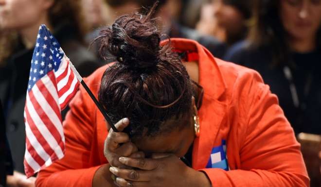 A supporter of US Democratic presidential nominee Hillary Clinton, reacts to elections results during election night at the Jacob K. Javits Convention Centre in New York. Photo: AFP