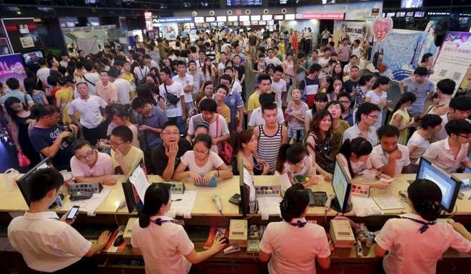 People wait for tickets at a ticket office of a movie theatre in Wuhan, Hubei province. Photo: Reuters