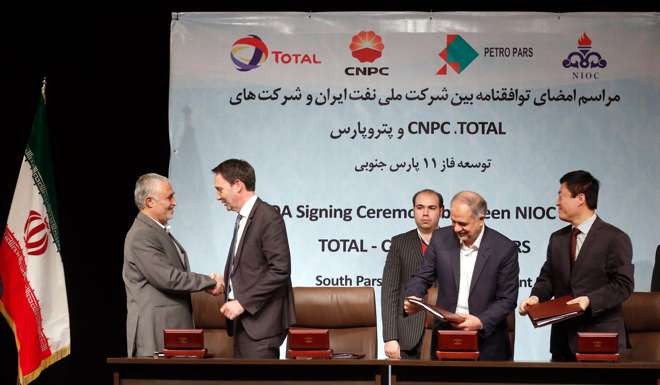 Officials from the National Iranian Oil Company Total Exploration & Production, PetroparsGroup, and China National Petroleum Corporation shake on agreement signed in Tehran, Iran, 08 November 2016. EPA/STR