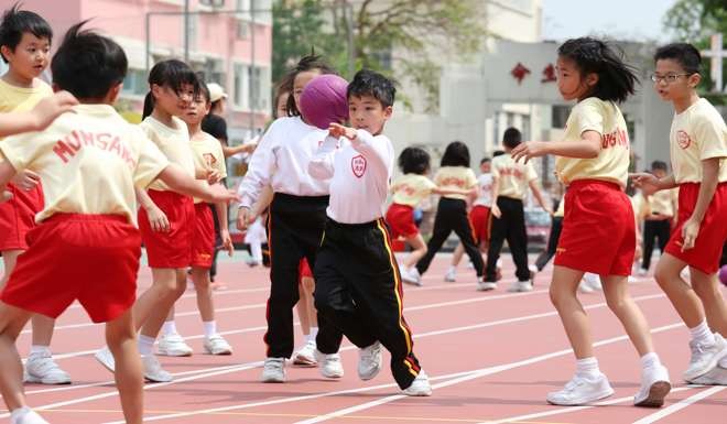 Primary Students at Munsang College playing in the campus sportsground in Kowloon City. 21APR16 SCMP/Nora Tam
