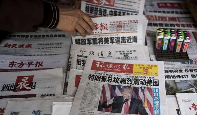 Chinese newspapers in Shanghai feature Donald Trump’s victory in the US presidential elections. Photo: AFP