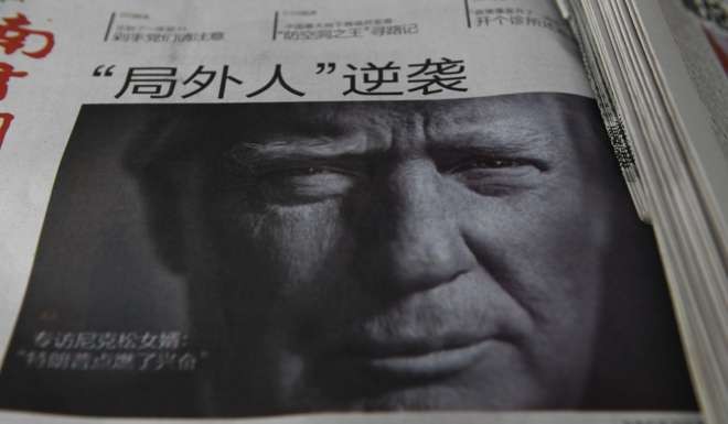 A Chinese newspaper with the headline ‘Outsider strikes back’ above a picture of Donald Trump. Photo: AFP