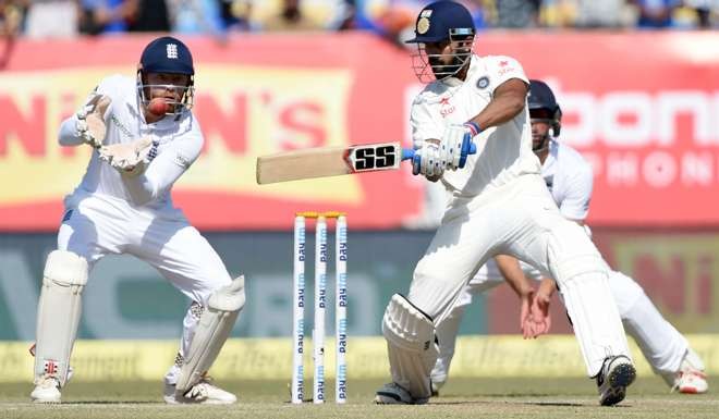 England wicketkeeper Jonny Bairstow (left) looks on as India's Murali Vijay plays a shot. Photo: AFP