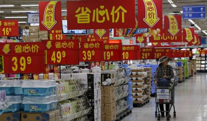 A woman shops at a supermarket in Beijing. Alibaba’s chief executive Zhang Yong noted in a recent interview that winning consumers and success in China’s online grocery market also called for a “full embracing of offline channels”. Photo: Reuters