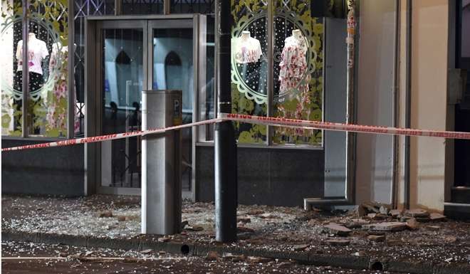 Shattered shop windows in Wellington. Photo: AP