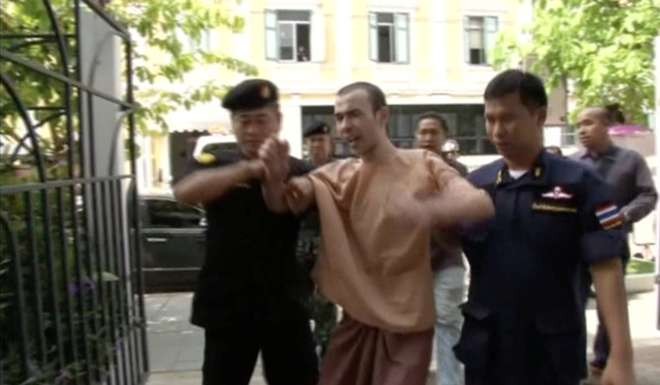 Adem Karadag, also known as Bilal Mohammed, a suspect in last year's Bangkok blast, shouting as he is escorted to court in Bangkok in May. Photo: Reuters