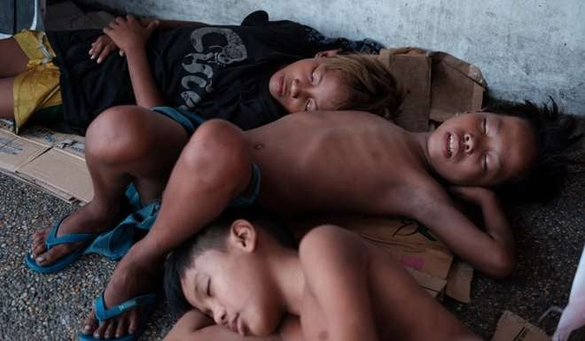 Sam and two other homeless boys sleep outside a supermarket near Agora Market. Picture: Paul Ratje