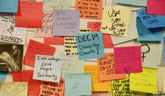 Messages written on post-it notes decorate a wall that was started in reaction to the election of President-elect Donald Trump in New York. Photo: Reuters