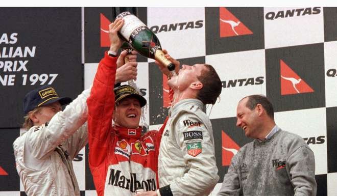 Scotland's David Coulthard has champagne poured onto him by fellow drivers Mika Hakkinen (L) and Germany's Michael Schumacher as his McLaren team boss Ron Dennis (R) looks on after he won the Australian Grand Prix in Melbourne in 1997. REUTERS