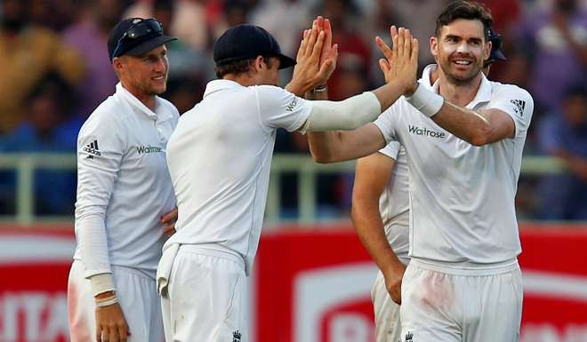 England's James Anderson celebrates with teammates after taking the wicket of India's Ajinkya Rahane.