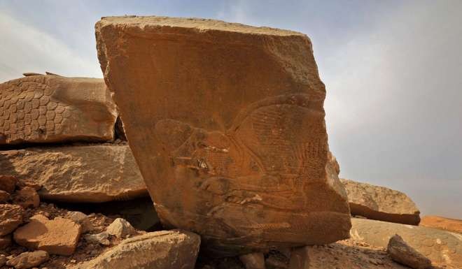 Ancient carvings are seen smashed and toppled at the archaeological site of Nimrud. Photo: AFP