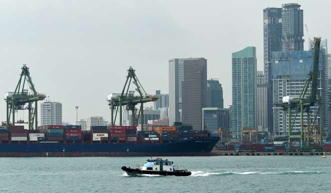 A boat passing Tanjong Pagar container port in Singapore. Photo: AFP