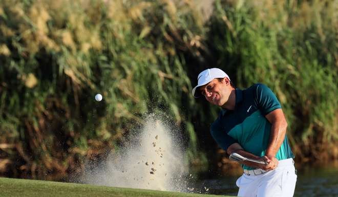 Francesco Molinari hits out of a bunker on the second day of the World Tour Championship. Photo: AFP