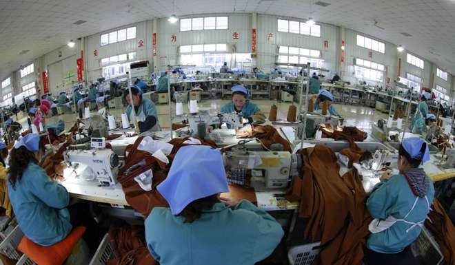 Employees work in a garment factory in Huaibei, Anhui province. Many migrant workers are forced to find other work after retirement as they do not qualify for pensions. Photo: Reuters