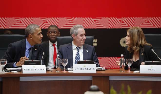 US President Barack Obama, left, talks with Second Vice-President of Peru Mercedes Araoz, right, watched by Ambassador Michael Froman, US Trade Representative, front centre, during a meeting of leaders of participating countries in the Trans Pacific Partnership in Lima, Peru, on Saturday. Photo: AP