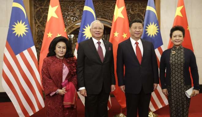 Malaysia's Prime Minister Najib Razak and his wife Rosmah Mansor meet China's President Xi Jinping and his wife Peng Liyuan at the Diaoyutai State Guesthouse in Beijing. Photo: AFP