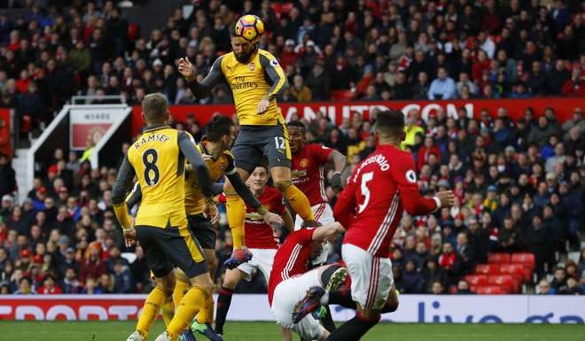 Arsenal's Olivier Giroud takes to the skies as he scores his side’s equaliser against Manchester United.
