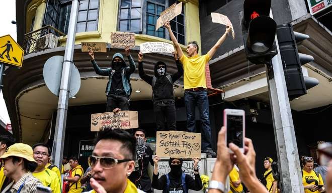 Protesters from Bersih display placards during a mass rally in Kuala Lumpur calling for the resignation of Malaysia’s Prime Minister Najib Razak. Photo: AFP