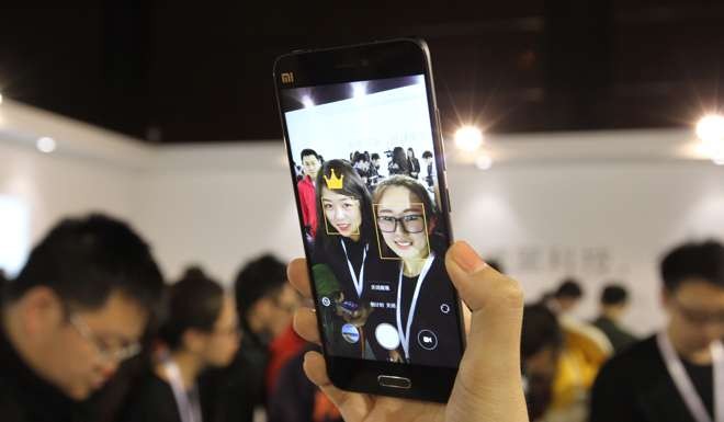 Time for a selfie, with a new Xiaomi 5 smart phone. The product was launched in February. Photo by Simon Song