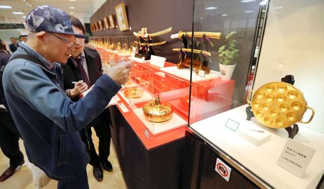 Visitors view a 43.2 million yen pure gold 