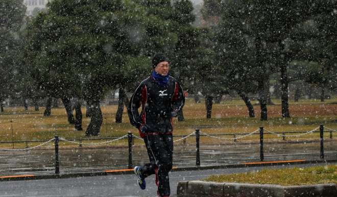 A jogger exercises near the Imperial Palace in Tokyo. Photo: Reuters