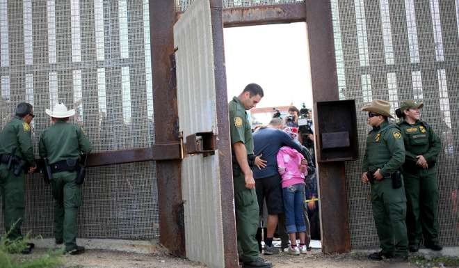 US border patrol agents allow family members living on both sides of the US-Mexico border to meet some days, when the “Door of Hope” is opened to allow face-to-face reunions for a few minutes. Trump has changed his tune about deporting all undocumented immigrants – he’s now talking about kicking out two to three million “criminals”. Photo: AFP