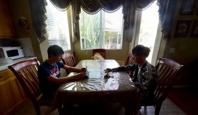 “Parachute kids” Tony Lu (left) from Anhui province and Henry Li (right) from Wuhan in Hubei province pictured at their host family's home in Murrieta, California, in March. Photo: AFP