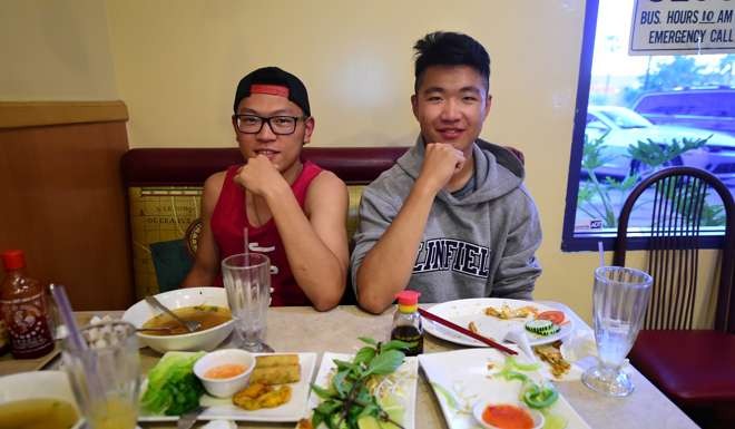 Overseas Chinese students Karl Li (left) from Jiangsu province and Wisdom Xiewei (right) from Chongqing pose for the camera after eating a Vietnamese dinner earlier this year. They were studying in Temecula, California. Photo: AFP