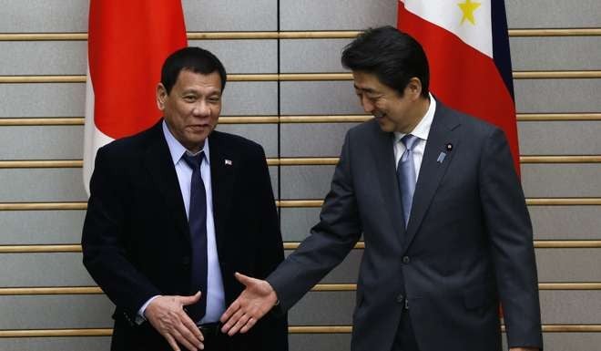 Philippine President Rodrigo Duterte is greeted by Japanese Prime Minister Shinzo Abe at the start of their meeting at Abe's official residence in Tokyo on October 26. Photo: EPA