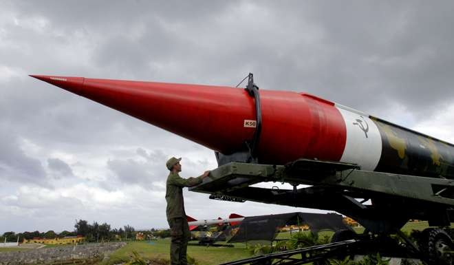 A soldier looks at the outer casing of an old empty Soviet missile on exhibit in October at a military complex open to tourists in Havana, Cuba. Photo: AP