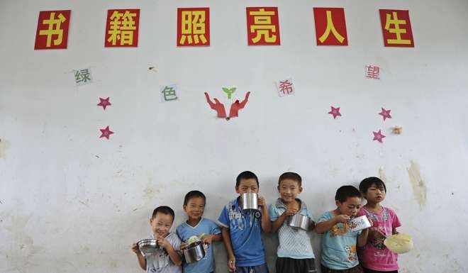 A sign reading ‘books light up lives’ in a classroom at Yangguang Primary School in Feidong county, Anhui province. Photo: Reuters